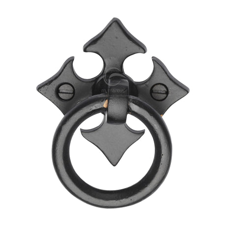 This is an image of a M.Marcus - Matt Black Rustic Iron Fleur-De-Lys Cabinet Ring Drop Pull, fb6331 that is available to order from T.H Wiggans Ironmongery in Kendal.