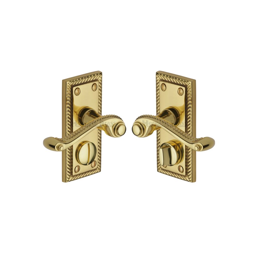 This is an image of a Heritage Brass - Door Handle for Privacy Set Georgian Short Design Polished Brass Fi, g055-pb that is available to order from T.H Wiggans Ironmongery in Kendal.