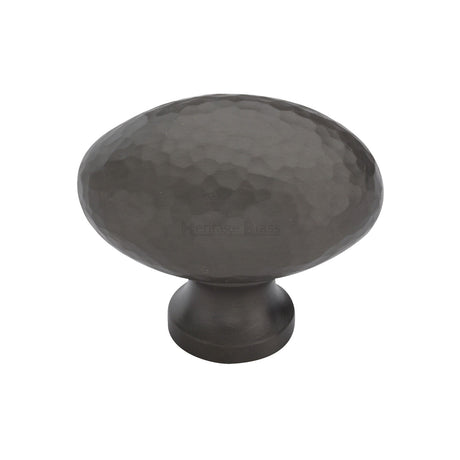 This is an image of a Heritage Brass - Cabinet Knob Victorian Oval Hammered Design 38mm Matt Bronze finish, ham114-38-mb that is available to order from T.H Wiggans Ironmongery in Kendal.