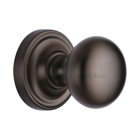 This is an image of a Heritage Brass - Mortice Knob on Rose Hampstead Design Matt Bronze Finish, ham8361-mb that is available to order from T.H Wiggans Ironmongery in Kendal.