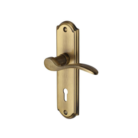 This is an image of a Heritage Brass - Door Handle Lever Lock Howard Design Antique Brass Finish, how1300-at that is available to order from T.H Wiggans Ironmongery in Kendal.