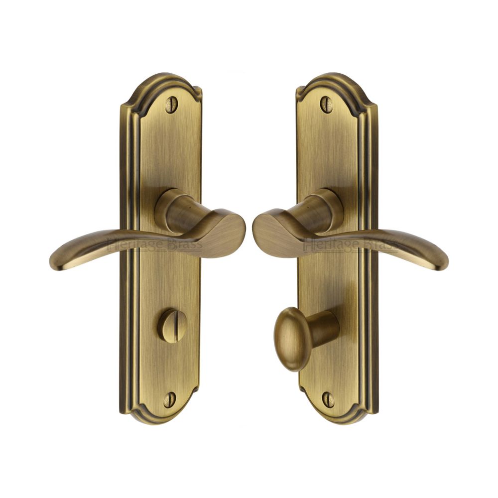 This is an image of a Heritage Brass - Door Handle for Bathroom Howard Design Antique Brass Finish, how1330-at that is available to order from T.H Wiggans Ironmongery in Kendal.