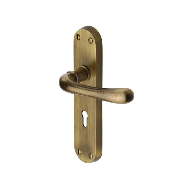 This is an image of a Heritage Brass - Door Handle Lever Lock Luna Design Antique Brass Finish, lun5300-at that is available to order from T.H Wiggans Ironmongery in Kendal.