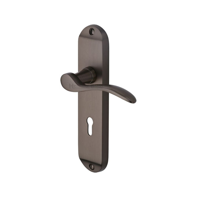This is an image of a Heritage Brass - Door Handle Lever Lock Maya Design Matt Bronze Finish, may7600-mb that is available to order from T.H Wiggans Ironmongery in Kendal.
