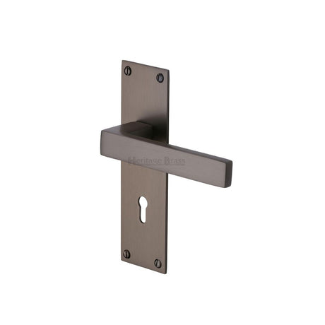 This is an image of a Heritage Brass - Door Handle Lever Lock Metro Design Matt Bronze Finish, met4900-mb that is available to order from T.H Wiggans Ironmongery in Kendal.