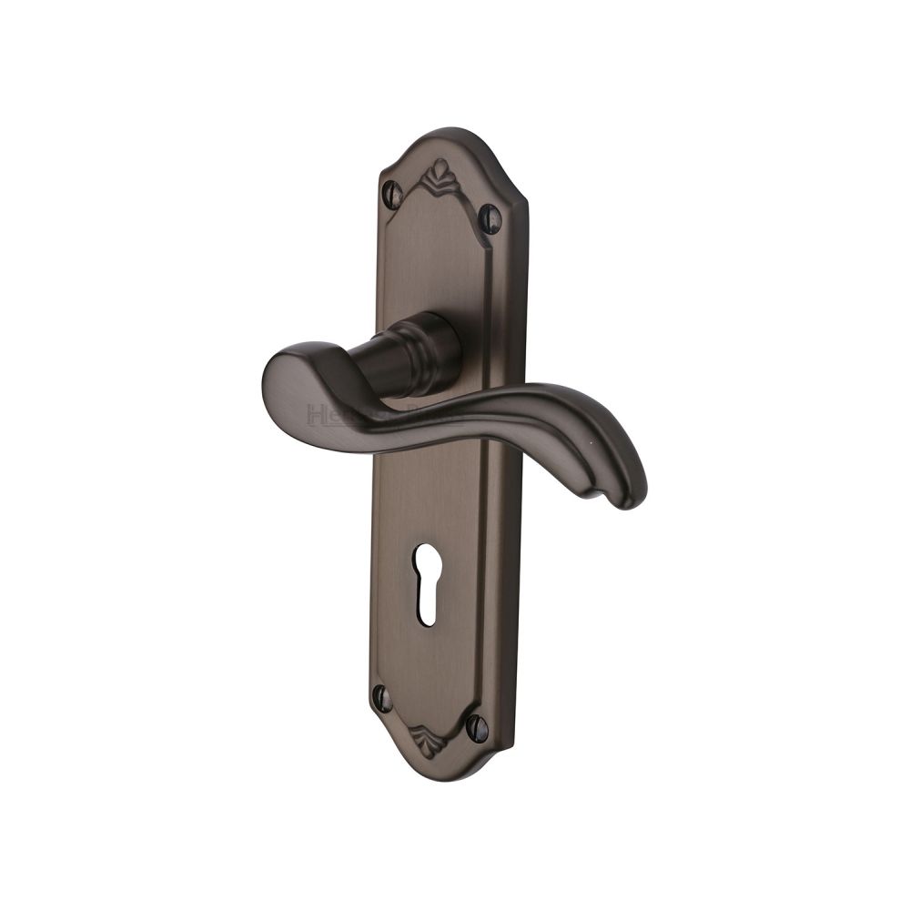 This is an image of a Heritage Brass - Door Handle Lever Lock Lisboa Design Matt Bronze Finish, mm991-mb that is available to order from T.H Wiggans Ironmongery in Kendal.