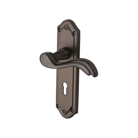 This is an image of a Heritage Brass - Door Handle Lever Lock Lisboa Design Matt Bronze Finish, mm991-mb that is available to order from T.H Wiggans Ironmongery in Kendal.