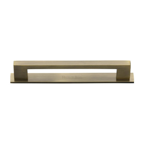 This is an image of a Heritage Brass - Cabinet Pull Metro Design with Plate 160mm CTC Antique Brass Finis, pl0337-160-at that is available to order from T.H Wiggans Ironmongery in Kendal.