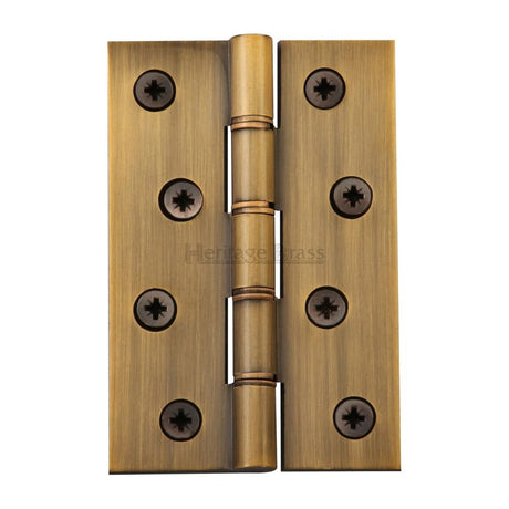 This is an image of a Heritage Brass - Hinge Brass with Phosphor Washers 4" x 2 5/8" Antique Brass Finish, pr88-405-at that is available to order from T.H Wiggans Ironmongery in Kendal.