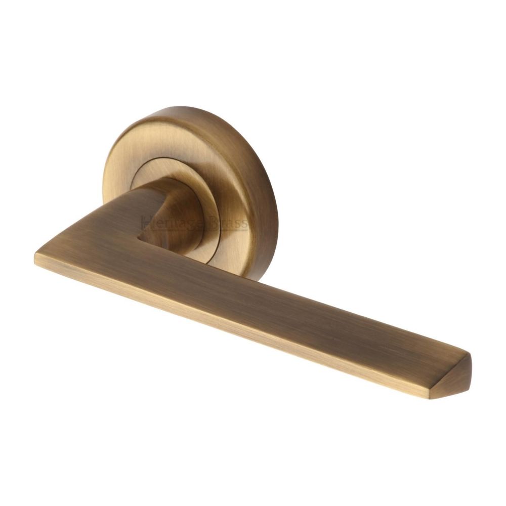 This is an image of a Heritage Brass - Door Handle Lever Latch on Round Rose Pyramid Design Antique Brass, pyd3535-at that is available to order from T.H Wiggans Ironmongery in Kendal.