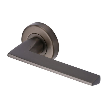 This is an image of a Heritage Brass - Door Handle Lever Latch on Round Rose Pyramid Design Matt Bronz, pyd3535-mb that is available to order from T.H Wiggans Ironmongery in Kendal.