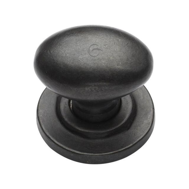 This is an image of a M.Marcus - Rustic Dark Bronze Cabinet Knob Oval Design on Rose 38mm, rdb179-38 that is available to order from T.H Wiggans Ironmongery in Kendal.