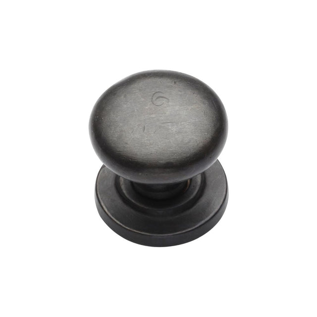 This is an image of a M.Marcus - Rustic Dark Bronze Cabinet Knob Round Design on Rose 25mm, rdb613-25 that is available to order from T.H Wiggans Ironmongery in Kendal.