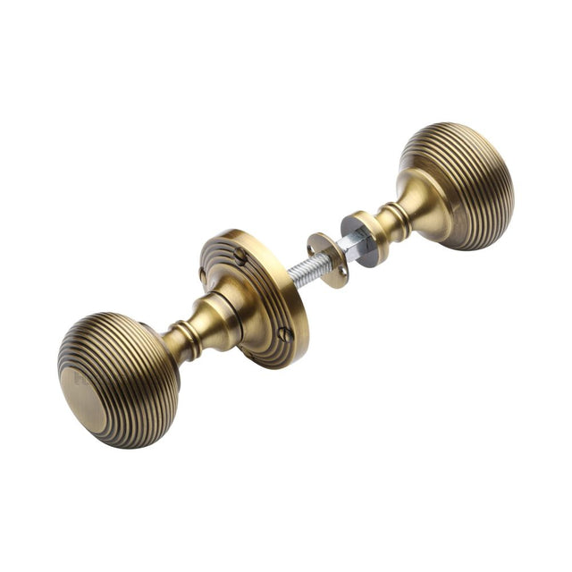 This is an image of a Heritage Brass - Reeded Rim Knob Antique Brass Finish, rim-v971-at that is available to order from T.H Wiggans Ironmongery in Kendal.