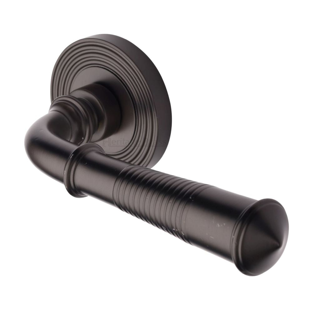 This is an image of a Heritage Brass - Door Handle Lever Latch on Round Rose Bridgetown Reeded Design, rr1935-mb that is available to order from T.H Wiggans Ironmongery in Kendal.