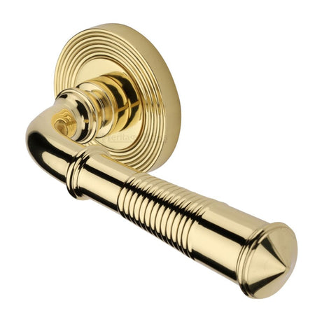 This is an image of a Heritage Brass - Door Handle Lever Latch on Round Rose Bridgetown Reeded Design, rr1935-pb that is available to order from T.H Wiggans Ironmongery in Kendal.