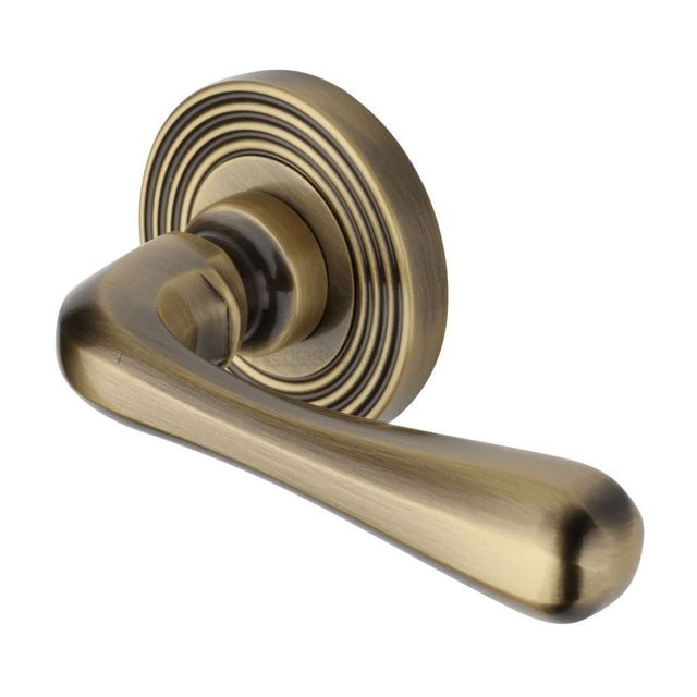 This is an image of a Heritage Brass - Door Handle Lever Latch on Round Rose Charlbury Reeded Design A, rr3022-at that is available to order from T.H Wiggans Ironmongery in Kendal.