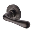 This is an image of a Heritage Brass - Door Handle Lever Latch on Round Rose Charlbury Reeded Design M, rr3022-mb that is available to order from T.H Wiggans Ironmongery in Kendal.
