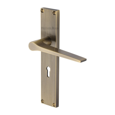 This is an image of a Heritage Brass - Gio Reeded Lever Lock Antique Brass finish, rr4700-at that is available to order from T.H Wiggans Ironmongery in Kendal.