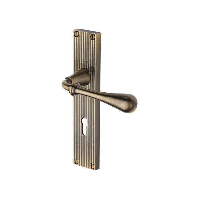 This is an image of a Heritage Brass - Roma Reeded Lever Lock Antique Brass finish, rr6000-at that is available to order from T.H Wiggans Ironmongery in Kendal.