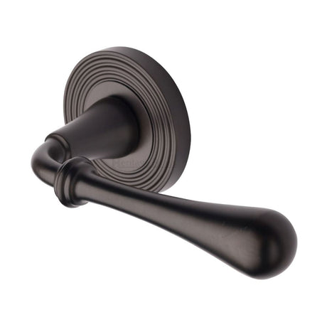 This is an image of a Heritage Brass - Door Handle Lever Latch on Round Rose Roma Reeded Design Matt B, rr7156-mb that is available to order from T.H Wiggans Ironmongery in Kendal.