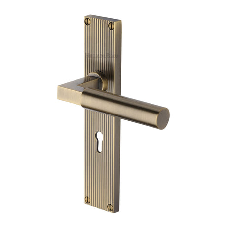 This is an image of a Heritage Brass - Bauhaus Reeded Lever Lock Antique Brass finish, rr7300-at that is available to order from T.H Wiggans Ironmongery in Kendal.