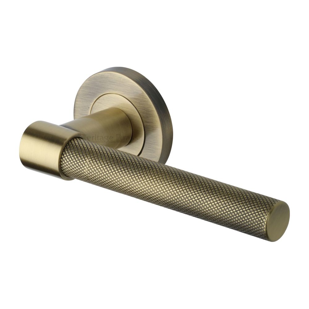 This is an image of a Heritage Brass - Door Handle Lever on Rose Phoenix Knurled Design Antique Brass Fin, rs2018-at that is available to order from T.H Wiggans Ironmongery in Kendal.