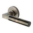 This is an image of a Heritage Brass - Door Handle Lever on Rose Spectral Design Antique Brass Finish, rs2261-at that is available to order from T.H Wiggans Ironmongery in Kendal.