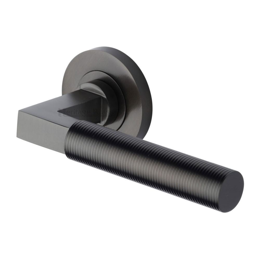 This is an image of a Heritage Brass - Door Handle Lever on Rose Spectral Design Matt Bronze Finish, rs2261-mb that is available to order from T.H Wiggans Ironmongery in Kendal.