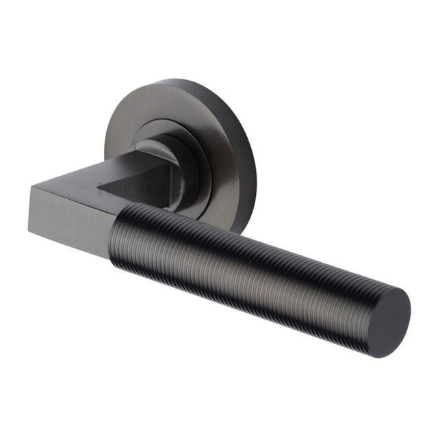 This is an image of a Heritage Brass - Door Handle Lever on Rose Spectral Design Matt Bronze Finish, rs2261-mb that is available to order from T.H Wiggans Ironmongery in Kendal.