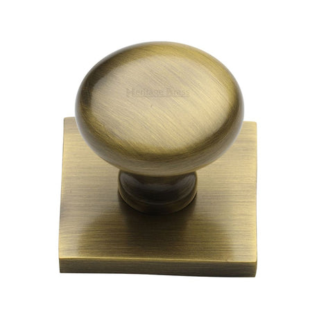This is an image of a Heritage Brass - Cabinet Knob Victorian Round Design with Square Backplate 32mm, sq113-at that is available to order from T.H Wiggans Ironmongery in Kendal.