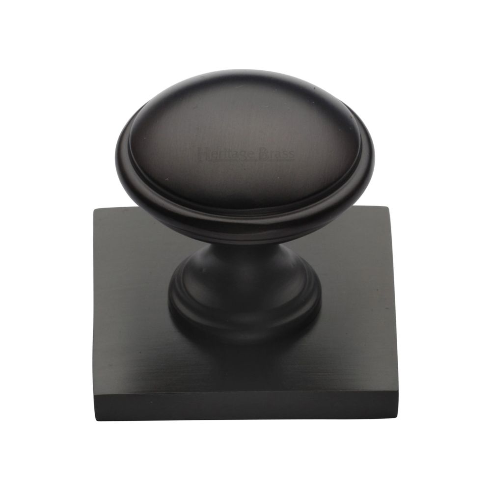 This is an image of a Heritage Brass - Cabinet Knob Domed Design with Square Backplate 32mm Matt Bronz, sq3950-mb that is available to order from T.H Wiggans Ironmongery in Kendal.