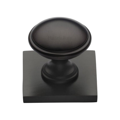 This is an image of a Heritage Brass - Cabinet Knob Domed Design with Square Backplate 32mm Matt Bronz, sq3950-mb that is available to order from T.H Wiggans Ironmongery in Kendal.