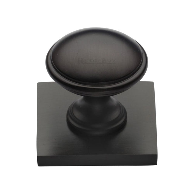 This is an image of a Heritage Brass - Cabinet Knob Domed Design with Square Backplate 32mm Matt Bronz, sq3950-mb that is available to order from T.H Wiggans Ironmongery in Kendal.