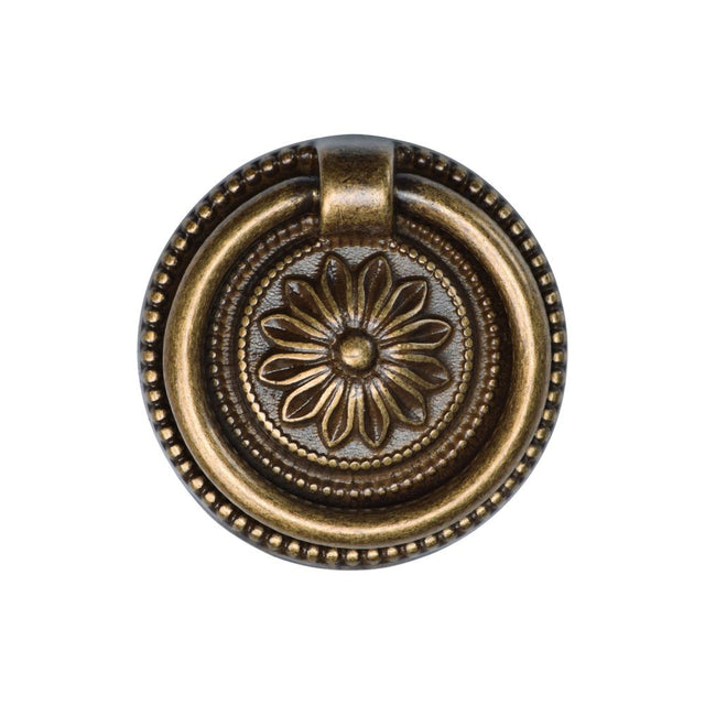 This is an image of a M.Marcus - Floral Ring Pull 055mm Distressed Brass Finish, tk2224-055-dbs that is available to order from T.H Wiggans Ironmongery in Kendal.