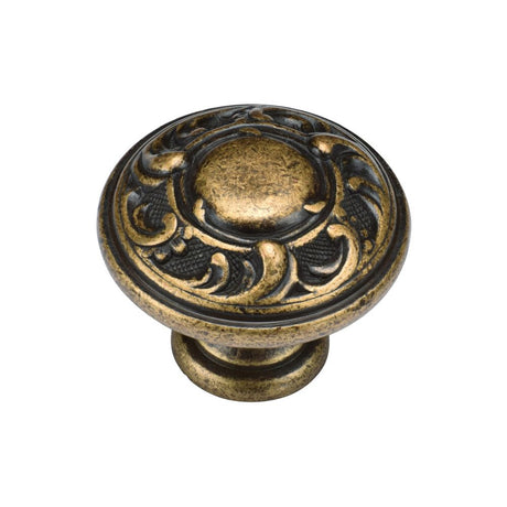 This is an image of a M.Marcus - Decorated Round Knob 035mm Distressed Brass Finish, tk4401-035-dbs that is available to order from T.H Wiggans Ironmongery in Kendal.