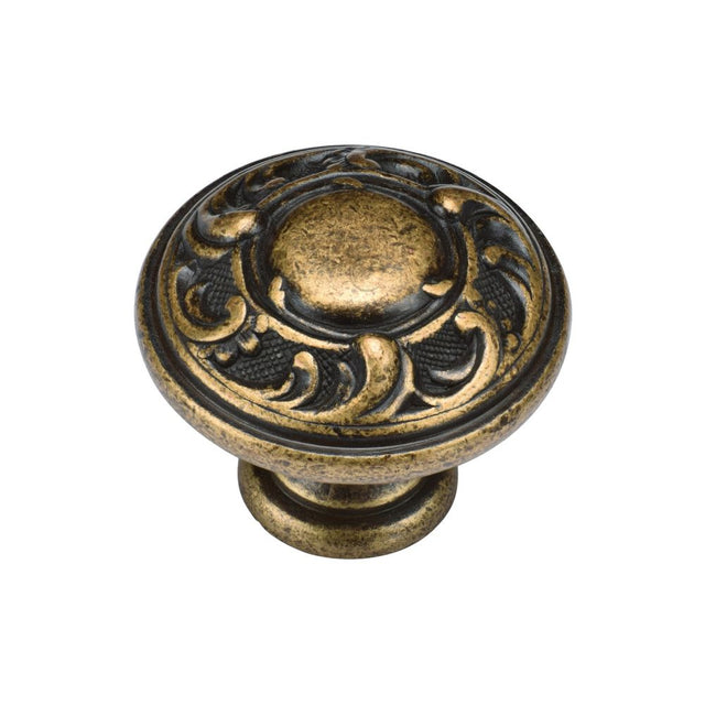 This is an image of a M.Marcus - Decorated Round Knob 035mm Distressed Brass Finish, tk4401-035-dbs that is available to order from T.H Wiggans Ironmongery in Kendal.