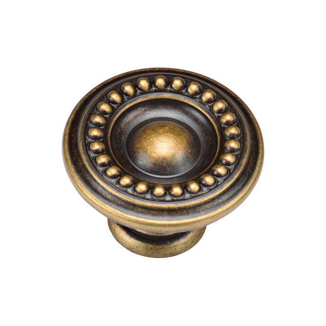 This is an image of a M.Marcus - Beaded Round Knob 035mm Distressed Brass Finish, tk4404-035-dbs that is available to order from T.H Wiggans Ironmongery in Kendal.