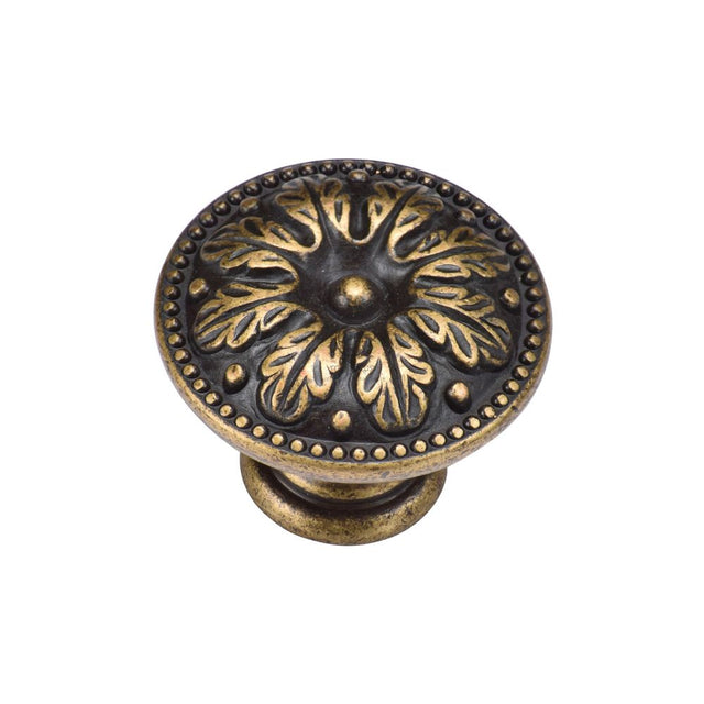 This is an image of a M.Marcus - Floral Round Knob 030mm Distressed Brass Finish, tk4479-030-dbs that is available to order from T.H Wiggans Ironmongery in Kendal.