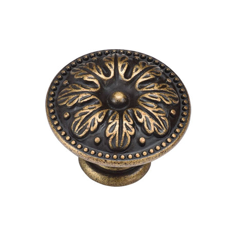 This is an image of a M.Marcus - Floral Round Knob 035mm Distressed Brass Finish, tk4479-035-dbs that is available to order from T.H Wiggans Ironmongery in Kendal.