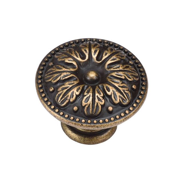 This is an image of a M.Marcus - Floral Round Knob 035mm Distressed Brass Finish, tk4479-035-dbs that is available to order from T.H Wiggans Ironmongery in Kendal.