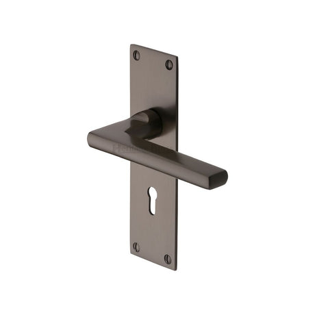 This is an image of a Heritage Brass - Door Handle Lever Lock Trident Design Matt Bronze Finish, tri1300-mb that is available to order from T.H Wiggans Ironmongery in Kendal.