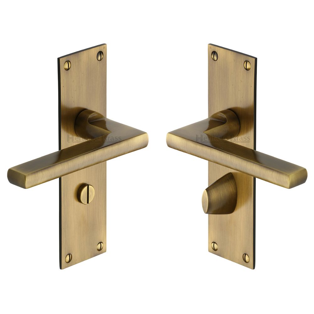 This is an image of a Heritage Brass - Door Handle Bathroom Set Trident Design Antique Brass Finish, tri1330-at that is available to order from T.H Wiggans Ironmongery in Kendal.