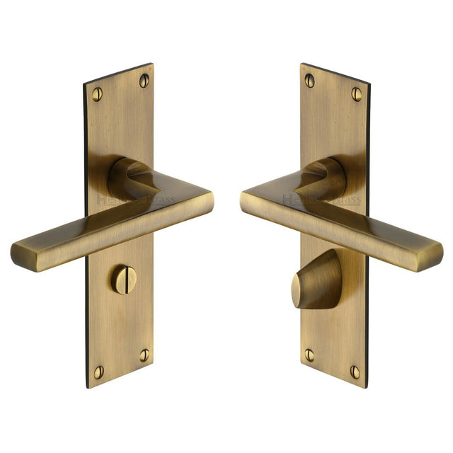 This is an image of a Heritage Brass - Door Handle Bathroom Set Trident Design Antique Brass Finish, tri1330-at that is available to order from T.H Wiggans Ironmongery in Kendal.