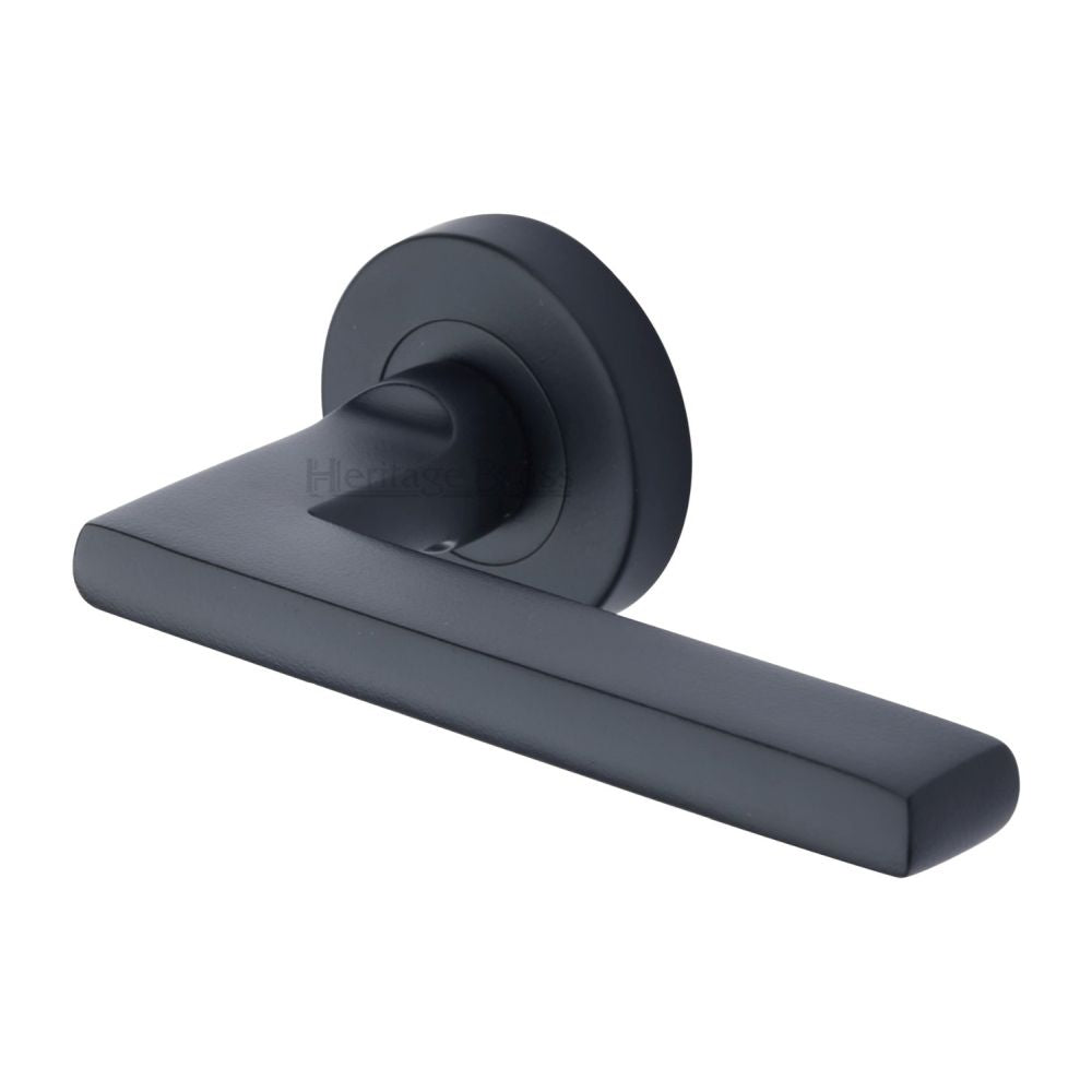 This is an image of a Heritage Brass - Door Handle Lever Latch on Round Rose Trident Design Matt Black, tri1352-bkmt that is available to order from T.H Wiggans Ironmongery in Kendal.