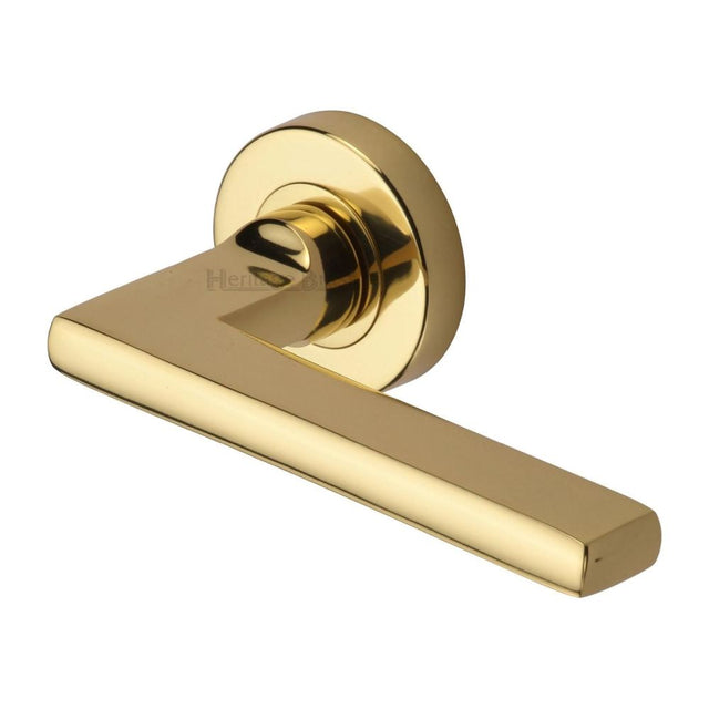 This is an image of a Heritage Brass - Door Handle Lever Latch on Round Rose Trident Design Polished Brass, tri1352-pb that is available to order from T.H Wiggans Ironmongery in Kendal.