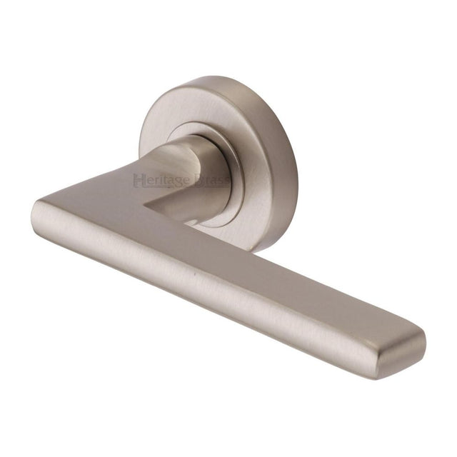 This is an image of a Heritage Brass - Door Handle Lever Latch on Round Rose Trident Design Satin Nicke, tri1352-sn that is available to order from T.H Wiggans Ironmongery in Kendal.