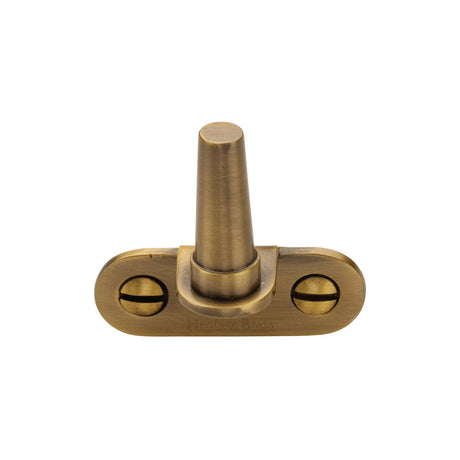 This is an image of a Heritage Brass - Cranked Casement Stay Pin Antique Brass finish, v1002-at that is available to order from T.H Wiggans Ironmongery in Kendal.