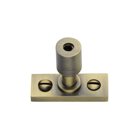 This is an image of a Heritage Brass - Casement Stay Locking Pin Antique Brass, v1007-at that is available to order from T.H Wiggans Ironmongery in Kendal.