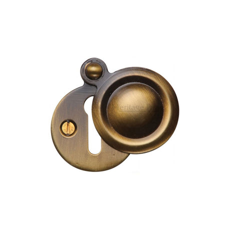 This is an image of a Heritage Brass - Covered Keyhole Round Antique Brass Finish, v1020-at that is available to order from T.H Wiggans Ironmongery in Kendal.